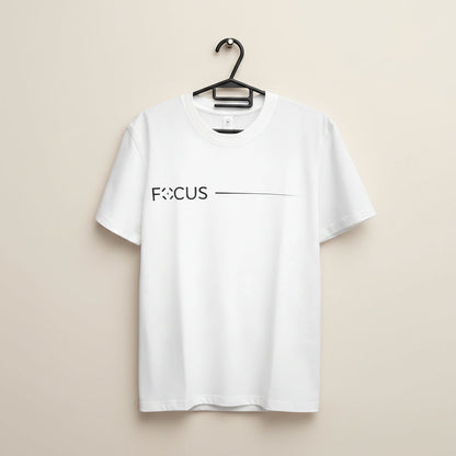 White t-shirt with 'FOCUS' text on a hanger against a brown background