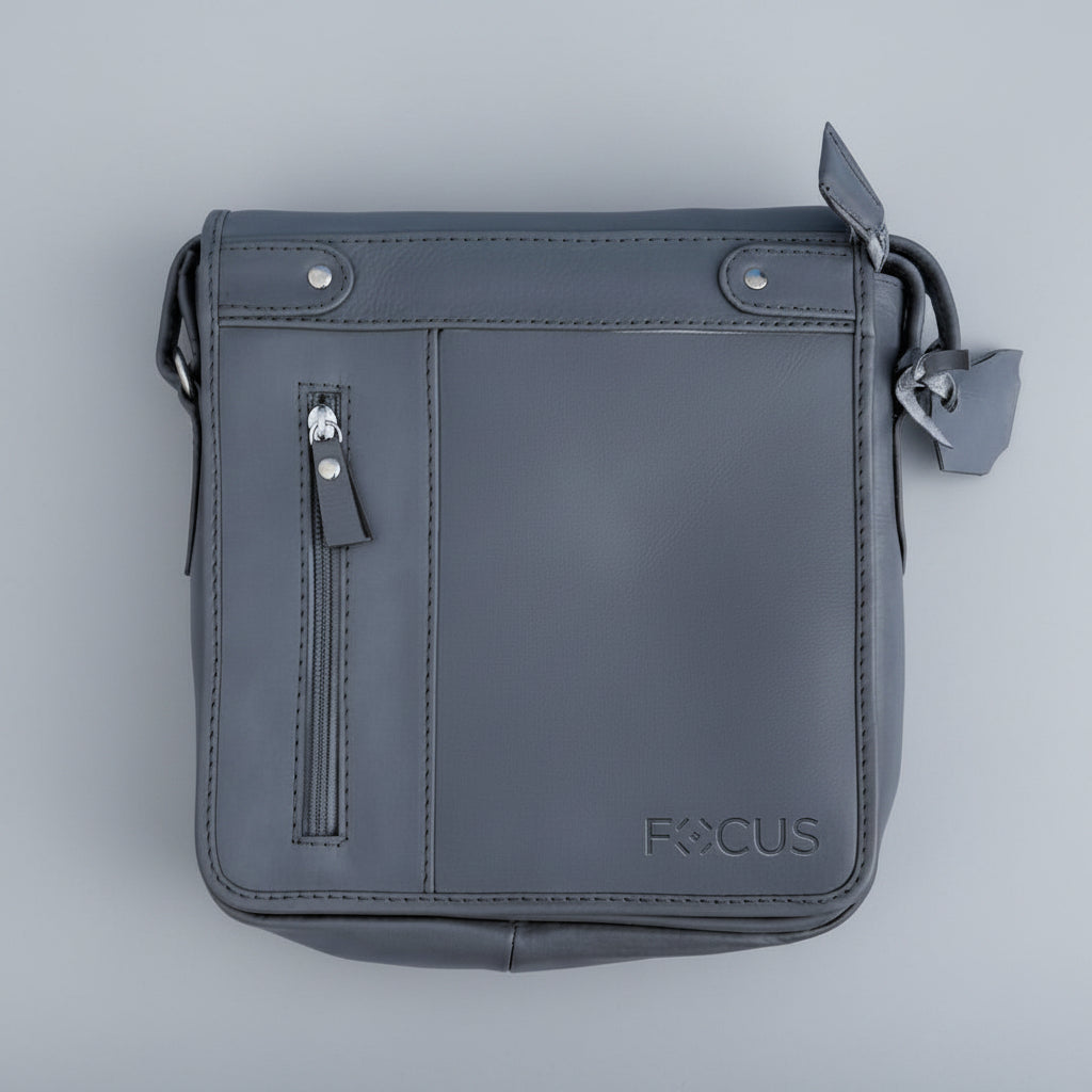 Gray leather crossbody bag with 'FOCUS' branding on a light blue background