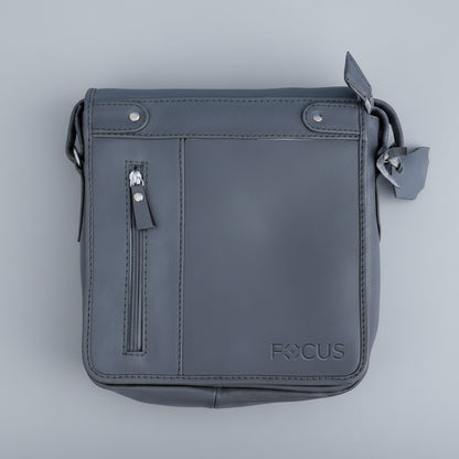 Gray leather crossbody bag with 'FOCUS' branding on a light blue background