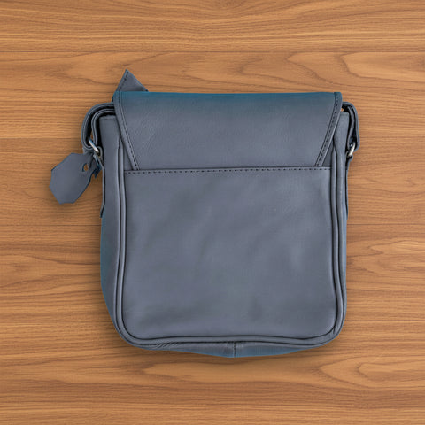 Gray leather crossbody bag on a white background