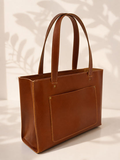 Brown leather tote bag on a light background