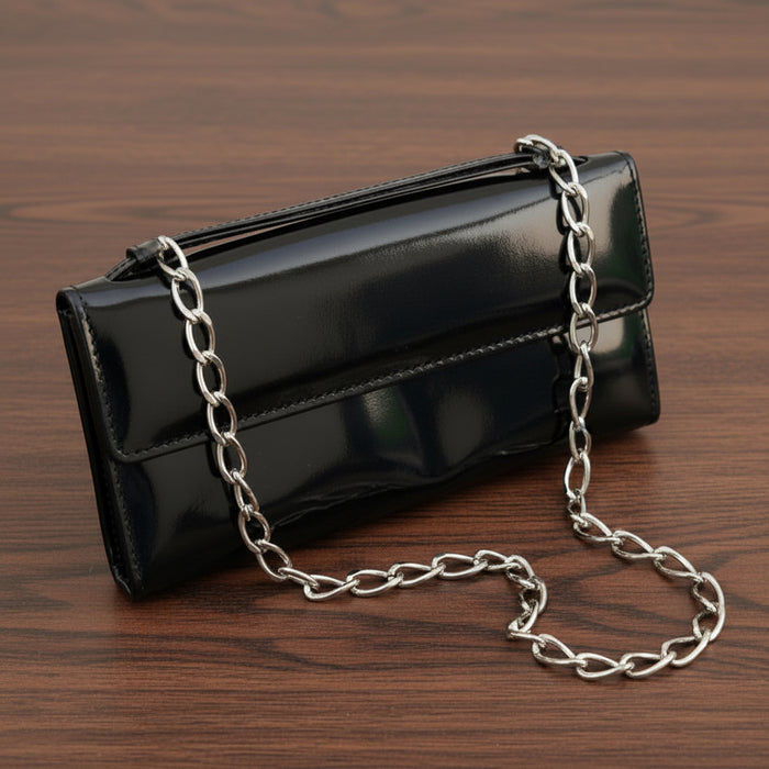 Black clutch bag on a blue background