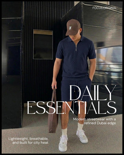 Man in navy polo shirt and shorts holding a bag, with 'Daily Essentials' branding.