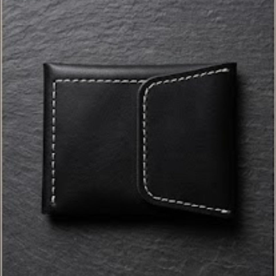 Black leather wallet on a textured gray background