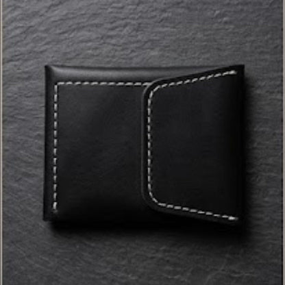 Black leather wallet on a textured gray background