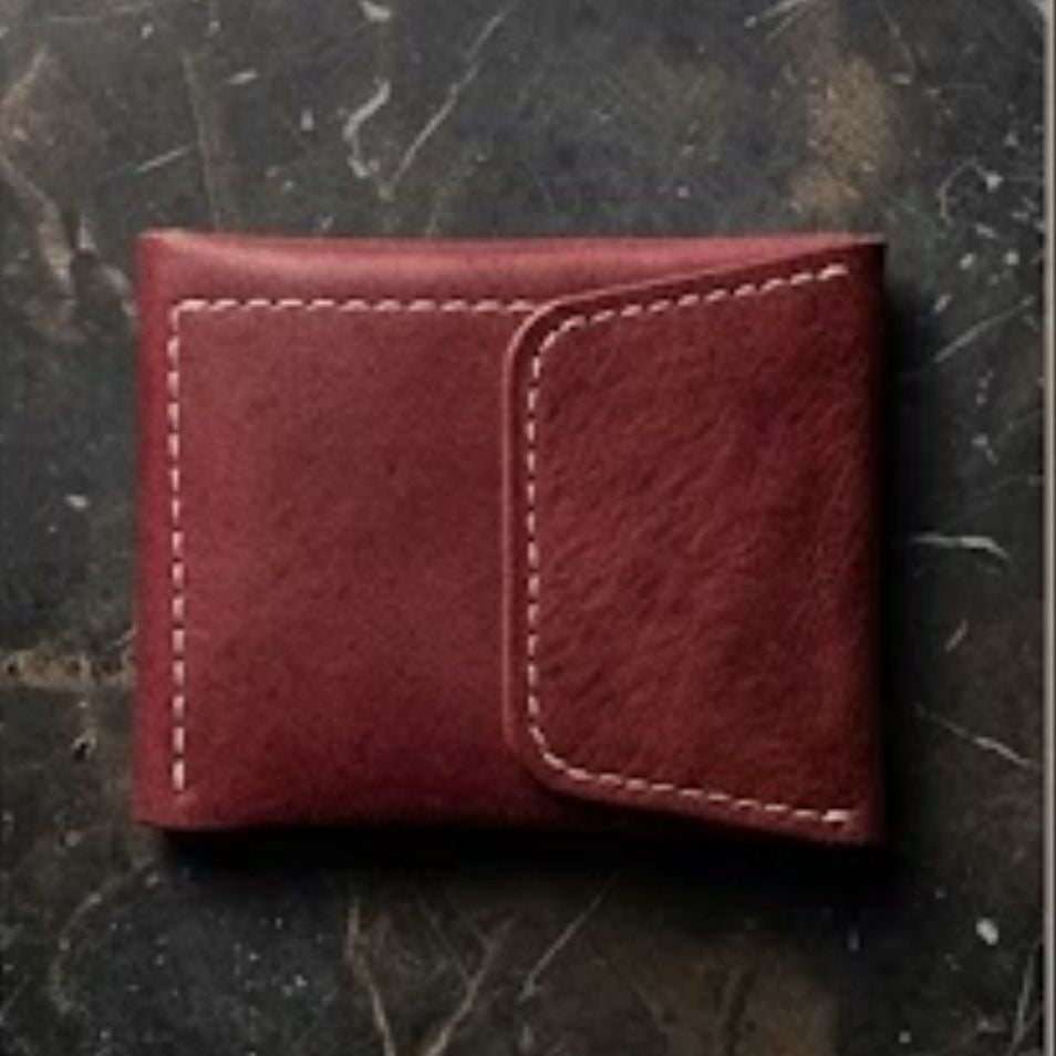 Red leather wallet on a textured dark surface