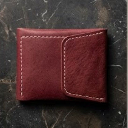 Red leather wallet on a textured dark surface