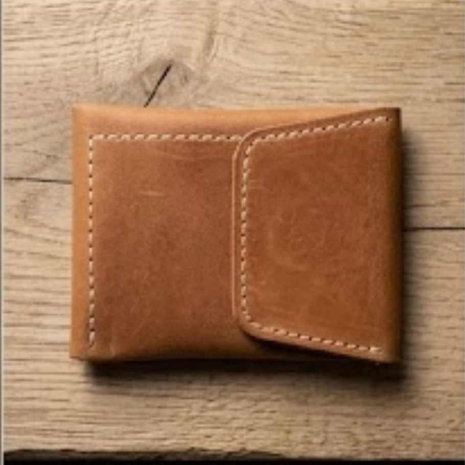 Brown leather wallet on a wooden surface